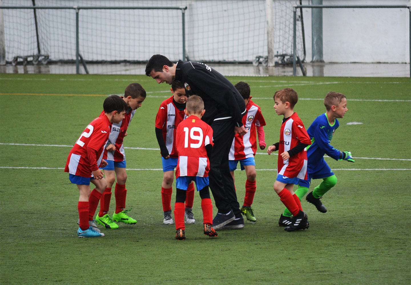 children playing football on astro turf