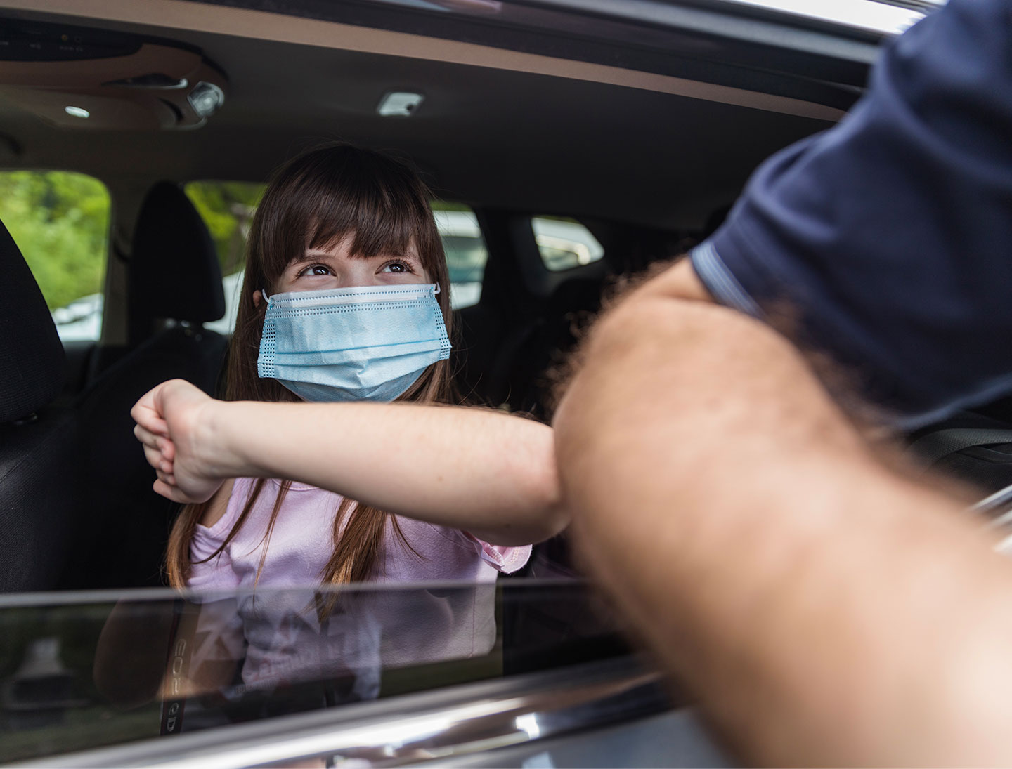 daughter and father bumping elbows