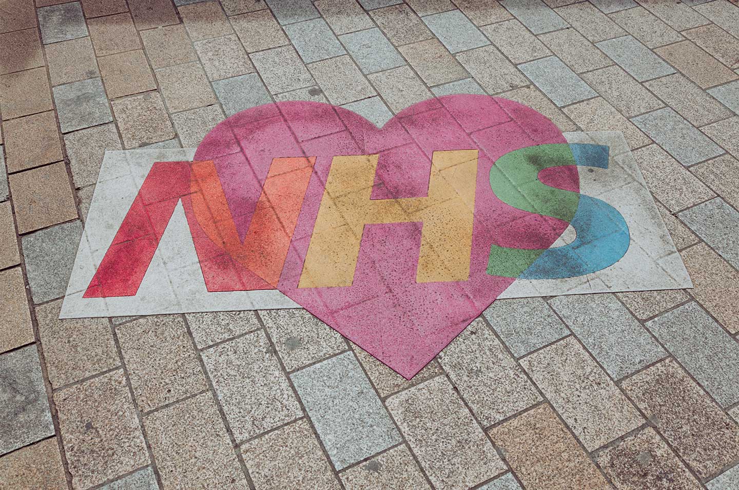nhs logo painted on a street
