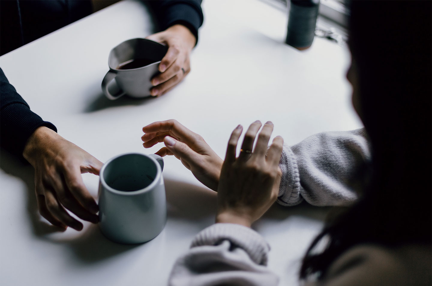 close up of hands holding coffee