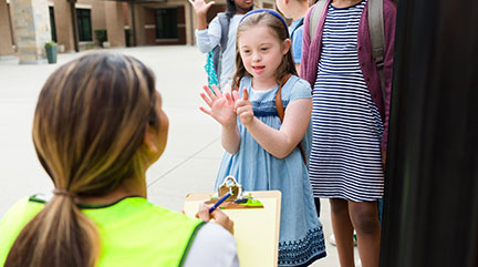 young girl signing to woman